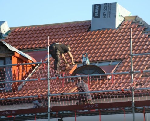A man on a roof working on a roof