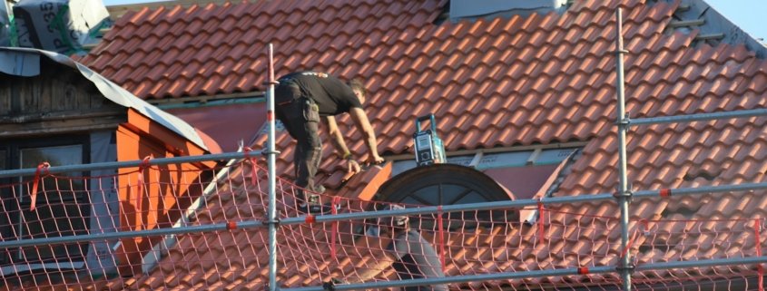 A man on a roof working on a roof